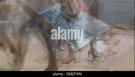 Image of hands of caucasian man with laptop over timelapse with diverse businesspeople Stock Photo