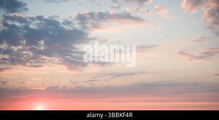 Subtle Sunset Sky: Pastel Clouds. Stock Photo