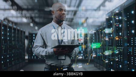 Futuristic Big Data Center with VFX: African American Administrator Using Digital Tablet. Animated Diagrams of Internet Traffic on Servers. Information Technology, Digitalization Concept. Medium Shot. Stock Photo