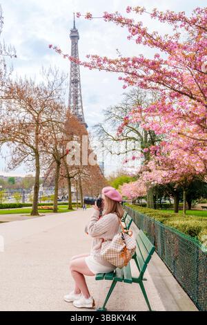 Woman enjoying the Cherry Blossoms (MR) Pink Cherry Blossoms blooming in April, Trocadero Garden 16th Arrondisement Paris, France,Europe Stock Photo