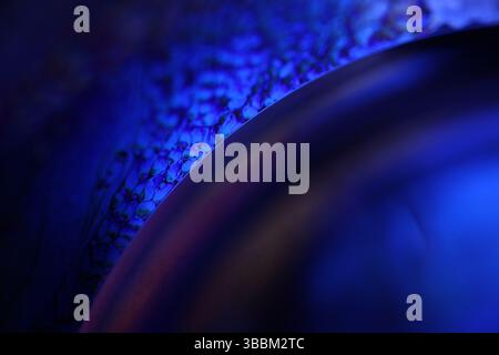 Deep purple liquid surface on black background, oil stains movement, bright chemistry, deep space background, connection lines Stock Photo