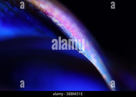 Deep purple liquid surface on black background, oil stains movement, bright chemistry, deep space background, connection lines Stock Photo