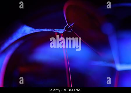 Deep purple liquid surface on black background, oil stains movement, bright chemistry, deep space background, connection lines Stock Photo