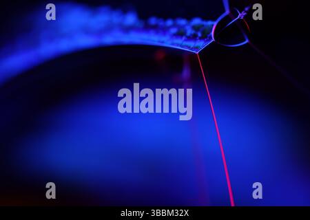 Deep purple liquid surface on black background, oil stains movement, bright chemistry, deep space background, connection lines Stock Photo