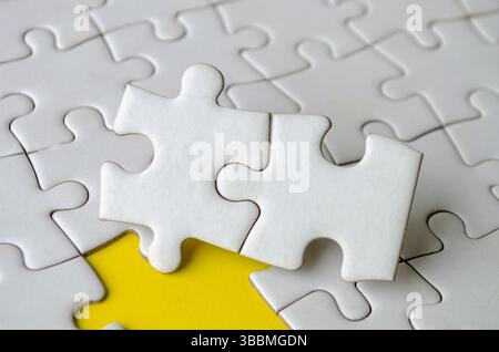 Jigsaw puzzle pieces removed from other jigsaw. Empty or blank jigsaw puzzle concept. Stock Photo