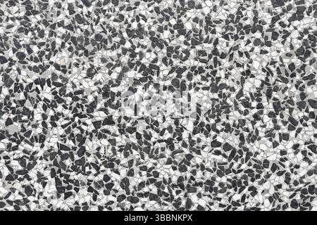 Stone terrazzo floor surface. Gray and white mosaic texture. Abstract construction pattern. Seamless decorative background. Stock Photo