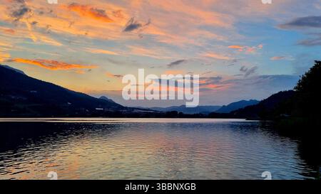 A fading fiery sunset over Lago di Caldonazzo in Italy Stock Photo