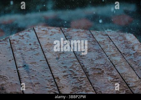 Raindrops on wooden table surface Stock Photo