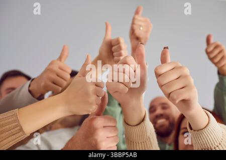 Team Showing Thumbs Up Gesture in Close Up Stock Photo