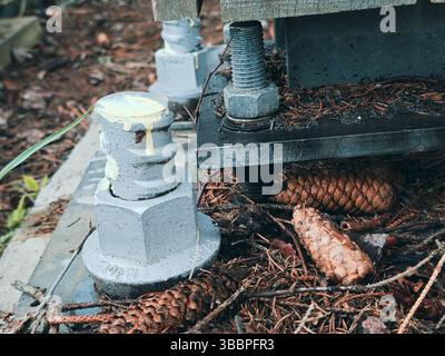 Reinforced concrete foundation with metal anchor bolts designed for the installation of metal columns. Foundation of warehouse on the construction sit Stock Photo