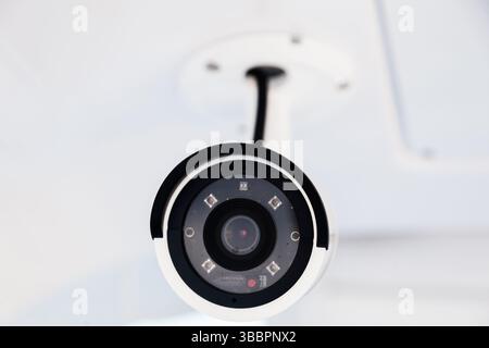 CCTV camera on the hull of an expensive motor yacht. CCTV camera white on a white body. Stock Photo
