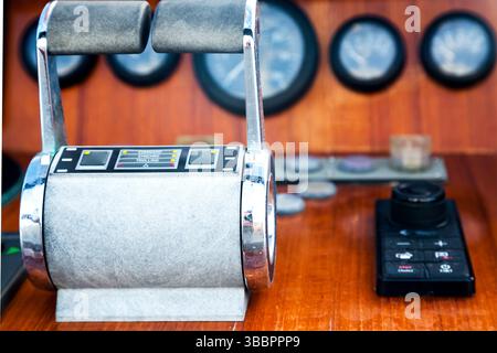 Motor yacht control panel. Gear levers, gauges, speedometers and control buttons. Stock Photo