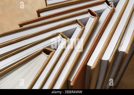 Many different half open books on beige grunge background Stock Photo