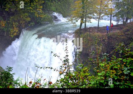 Rastoke Croatia. October 8 2015. Majestic waterfall in the middle of green and orange trees viewed on a misty rainy afternoon Stock Photo