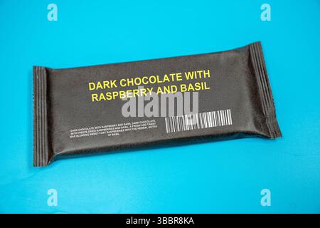 Dark chocolate with raspberry and basil. A fresh and tangy bar blending sweet-tart raspberries with the herbal notes of basil. Stock Photo