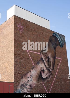 Closeup of Houston, Texas, 'Inexorable' mural depicting a fist bump with both hands having tattoos by nomad.clan that supports the LGBTQ community. Stock Photo