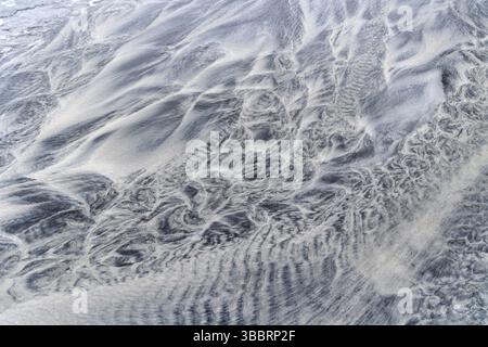 Sand patterns carved through running trickles on the famous Skagsanden beach in Lofoten, Norway Stock Photo