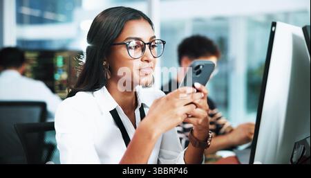 Computer, businesswoman and programmer with smartphone in office, coding software and download app. Coworking, female person and developer with mobile Stock Photo