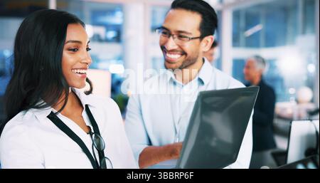 Smile, people and developer with laptop in office of programming, coding training and check server. Team, mentor and helping for app testing, IT Stock Photo