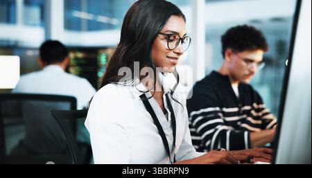 Happy, woman and developer on computer in office for programming, software update and troubleshooting. Female person, pc and coding app with website Stock Photo