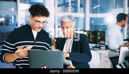 Man, developer and mentor on laptop in office for programming, coding training and server update. People, manager and help for testing pc, IT intern Stock Photo