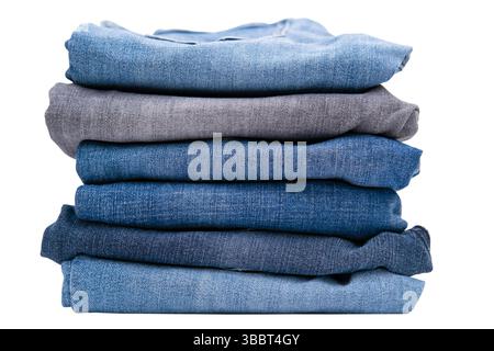 Stack of different jeans isolated on a white background. Stock Photo
