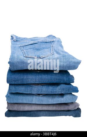 Stack of different jeans isolated on a white background. Stock Photo