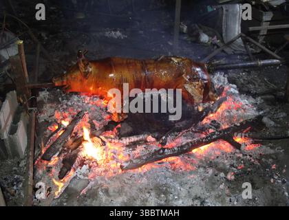 Pig being roasted on Charcoal Stock Photo