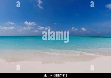 Peaceful sunny beach gentle waves inspiring blue sky soft white clouds calm seascape summer nature background relaxation coastal vacation landscape Stock Photo