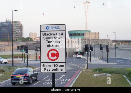 A road-charge warning sign at the Silvertown Tunnel entrance states: ‘Blackwall & Silvertown Tunnels Charge’ , a toll applies for drivers using it, UK Stock Photo