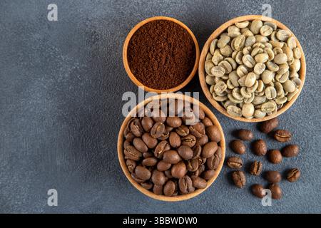 Green coffee with roasted coffee beans on black background Stock Photo