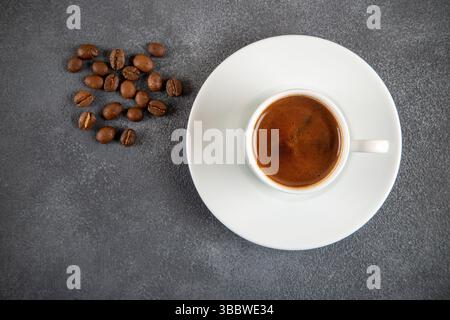 Coffee beans roasted with a cup of Turkish coffee on the gray concrete background Stock Photo