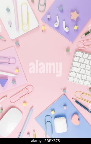 Top view of white keyboard, mouse, touchpad, earphones case, pen on pink background. Purple, pink and blue notebooks, pens, pencils, paper clips. Stock Photo