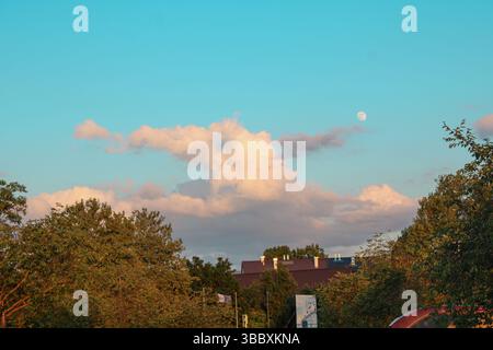 Early Evening Sky with Clouds and Moon Stock Photo