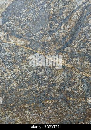 Weathered rock surface with intricate patterns and cracks. Stock Photo