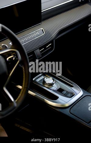 Selector automatic transmission with leather in the interior of a modern expensive car. Black and brown leather car. Modern automatic gearbox. Close u Stock Photo