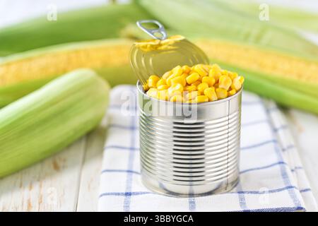 sweet canned corn on a white table, selective focus. Stock Photo