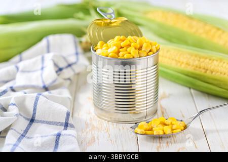 sweet canned corn on a white table, selective focus. Stock Photo
