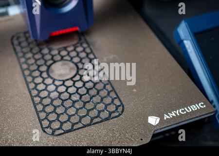 Jurmala, Latvia - 10.05.2025: Printing model with Anycubic Kobra 2 PRO 3D printer. 3D Printer in Action Creating Intricate Designs on a Build Plate Stock Photo