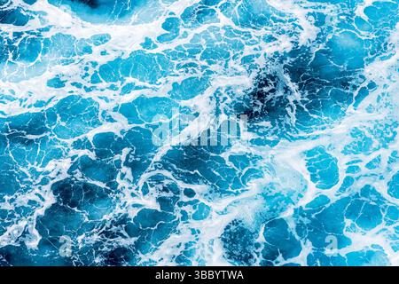 Abstract photo of water surface with shapes and form are created by moving waves and foam Stock Photo