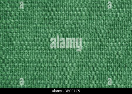 Texture of green natural fabric with large weaving. Surface, structure of upholstery or carpet material, cloth background close up. Stock Photo
