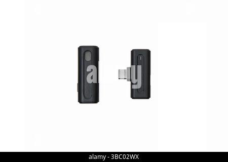 Close-up of a wireless lavalier microphone and USB-C receiver isolated on white background. Stock Photo
