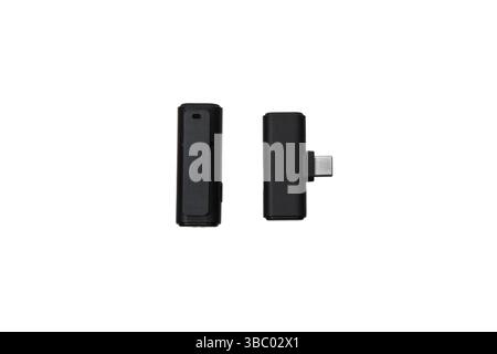 Close-up of a wireless lavalier microphone and USB-C receiver isolated on white background. Stock Photo