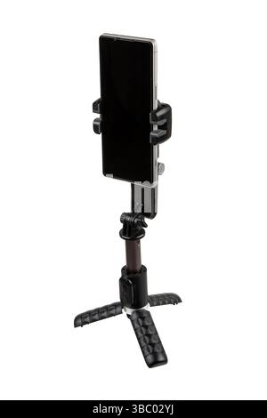 Smartphone mounted on compact gimbal stabilizer tripod, isolated on white background. Stock Photo