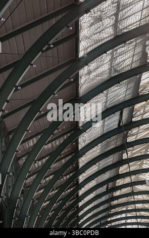 London, UK - May 13, 2025 - Architecture greco-roman style with iron glass roof and light bulbs on the ceiling in Covent Garden Market Hall. View of M Stock Photo