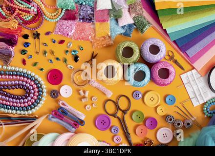 Craft and hobby materials top view on the orange background. DIY objects flat lay Stock Photo