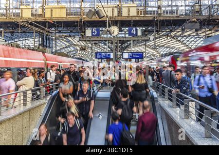 Cologne Central Station. Stairs to the platforms. Travellers waiting for their train on the platform. Crowd with motion blur. Cologne, North Rhine-Wes Stock Photo