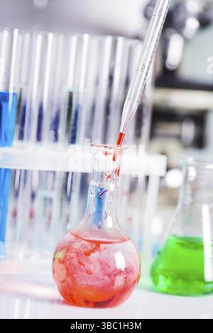Scientist shows a diffusion in the flask Stock Photo