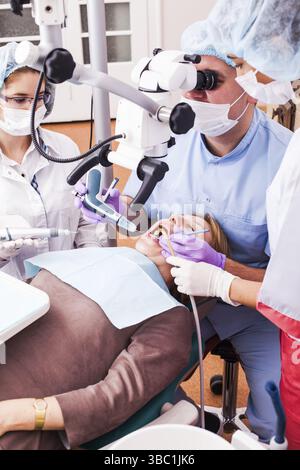 Dental surgery procedure in dental office, medical doctors team is doing dental operation Stock Photo