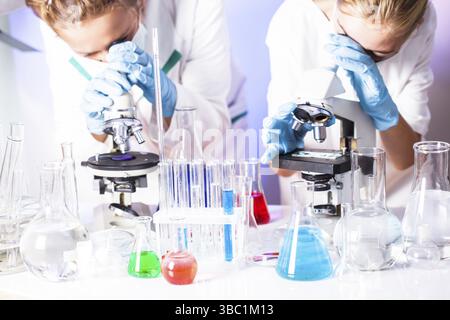 Two scientists in the chemical laboratory are doing experiments Stock Photo
